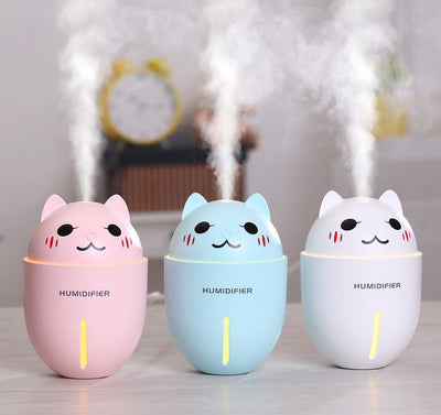 Meng pet cat humidifier in pink, blue, and white with cartoon cat design emitting mist