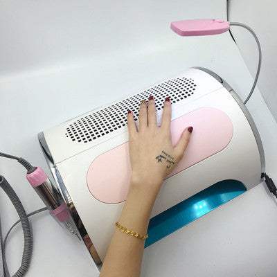 multi-function nail cleaner with hand resting on device featuring LED light and vacuum components