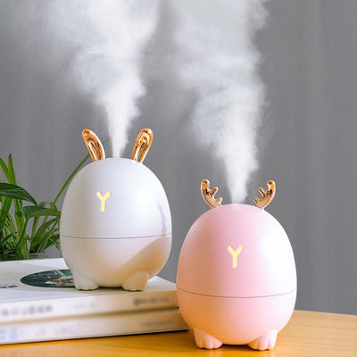 Cute USB humidifier with cartoon deer and rabbit design releasing mist for air purification and skin hydration