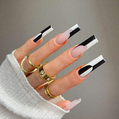 Black and white color matching long removable nail tips on hand with gold rings